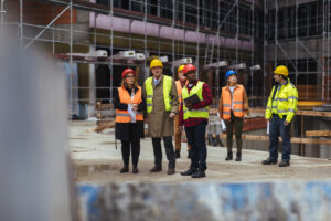 Developer, engineers, architects and other workers on the project site of an ongoing building construction project