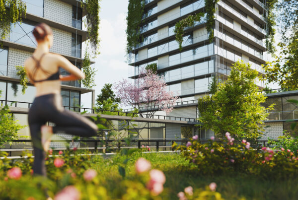 Woman practicing yoga on terrace garden in a sustainable green housing complex