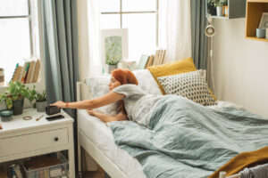 A female student lying in the bed of her dorm