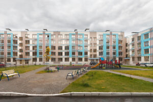 Multi-family housing architecture design featuring a children’s playground with multiple beaches around it.