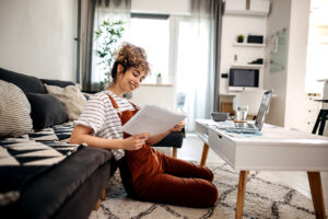 Female student studying in her dorm room using a laptop - improving connectivity in your student housing architecture.