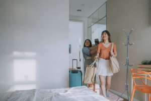 Two female college students moving into their new apartment - student housing architecture.