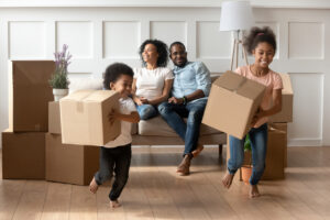 A family starting to unpack their boxes in their new living room - multi-family architecture concept.