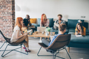 Group of college students studying together in a dorm’s lounge area - student housing design concept