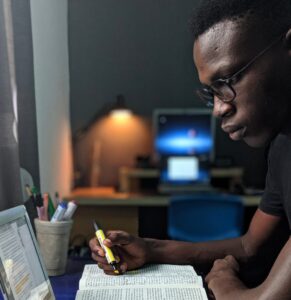 Student quietly studying in dorm